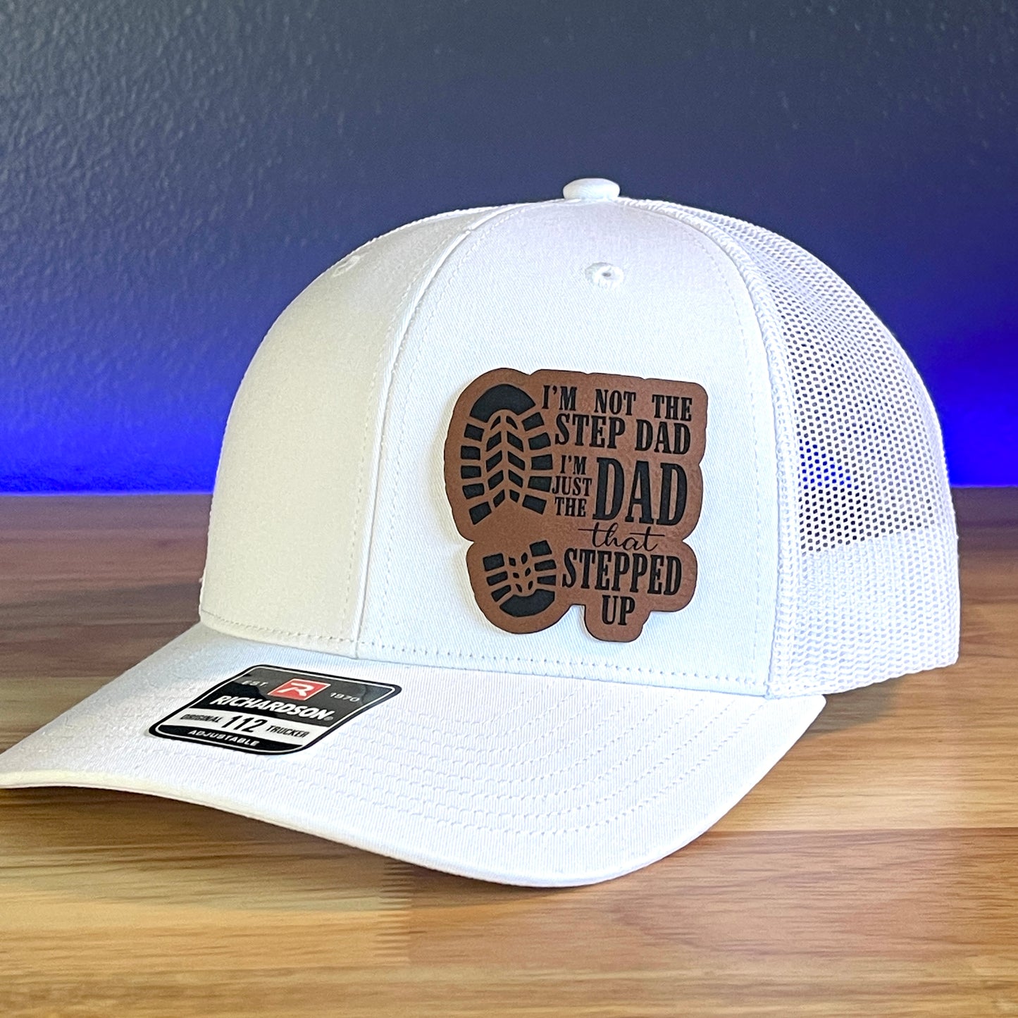 I'M NOT THE STEP DAD, IM THE DAD THAT STEPPED UP Leather Patch Trucker Hat White