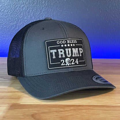 GOD BLESS TRUMP 2024 SnapBack Trucker Leather Blk/Silver Rectangular Patch Charcoal Hat